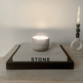 Boulder concrete candle on stacked books