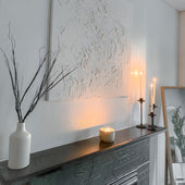 Boulder concrete candle burning on a mantel