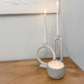 Boulder concrete candle burning on a wooden sideboard