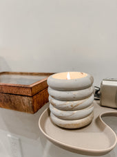 Gem concrete candle with gilded paint on a tray