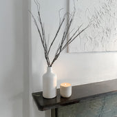 Pebble concrete candle burning on a mantel